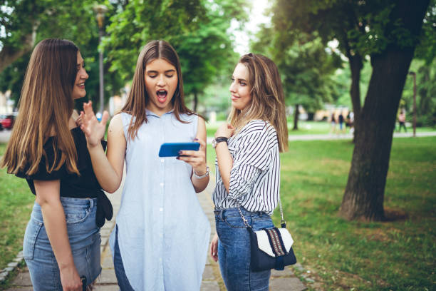 istock Three girls on phone 1164074053
