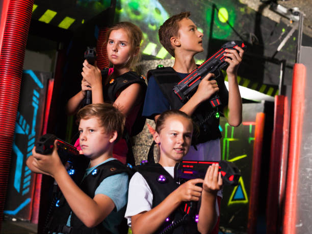 istock Happy teenagers with laser guns 1164074097