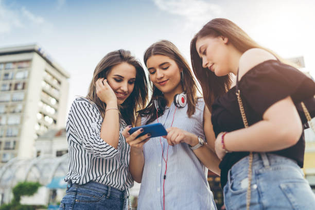 istock Three friends looking at phone 1164074169
