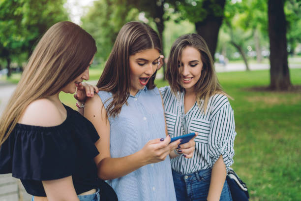 istock Three girls on phone 1164074191
