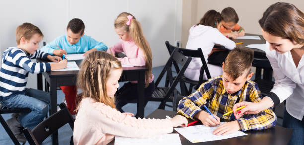 istock Children of elementary age having class of art 1164076499