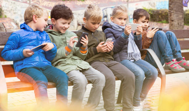istock Five kidsare chatting on their smartphone 1164077613