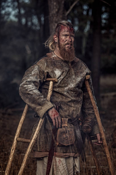 istock Sword wielding one legged bloody viking warrior alone in a forest 1164077665