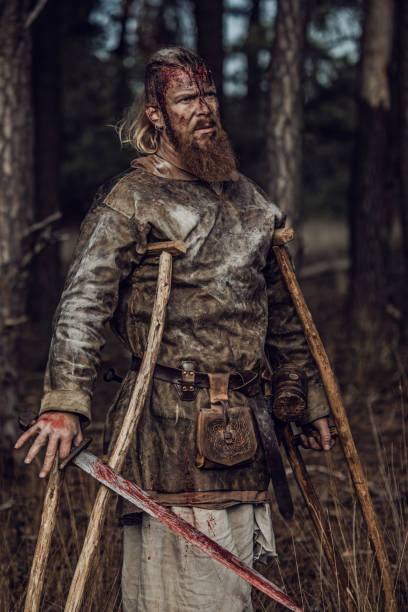 istock Sword wielding one legged bloody viking warrior alone in a forest 1164077669