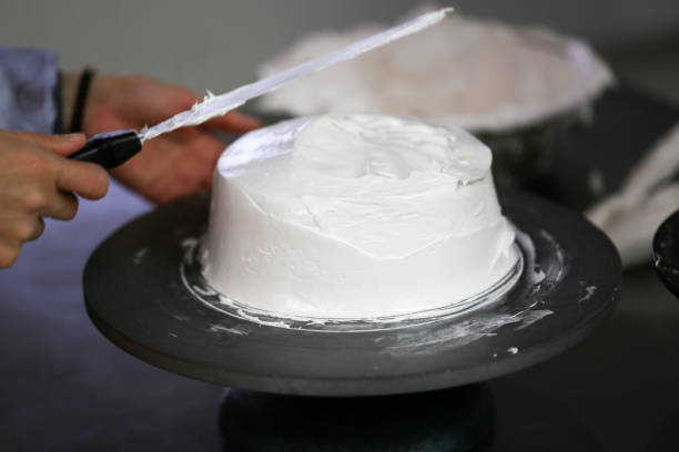istock making cake coved with cream by knife 1164077711