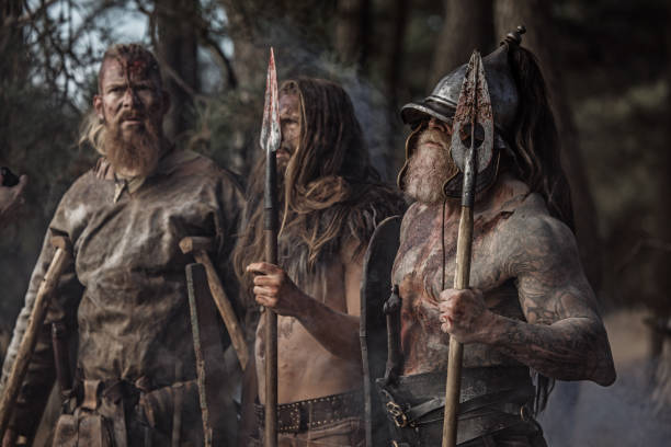 istock Three Sword wielding bloody viking warriors in a forest 1164077829