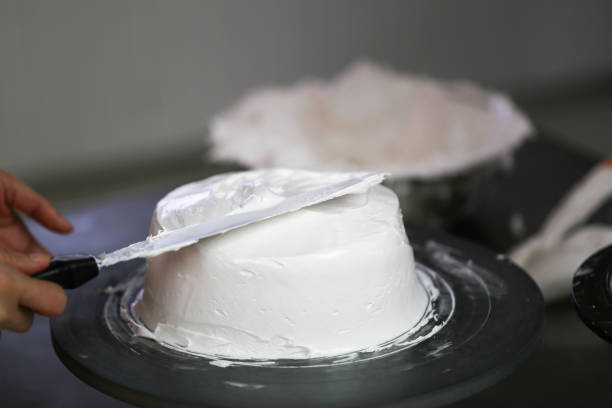 istock making cake coved with cream by knife 1164077845