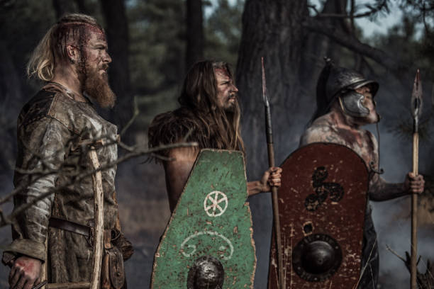 istock Three Sword wielding bloody viking warriors in a forest 1164077900