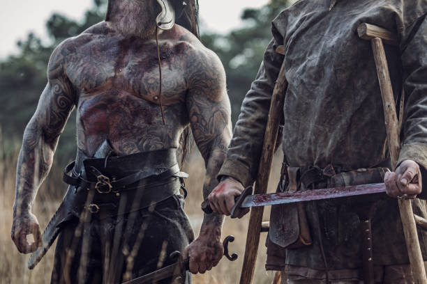 istock Two Sword wielding bloody viking warriors alone in a forest 1164078477
