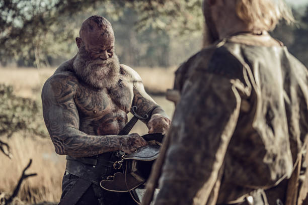 istock Two Sword wielding bloody viking warriors alone in a forest 1164078823