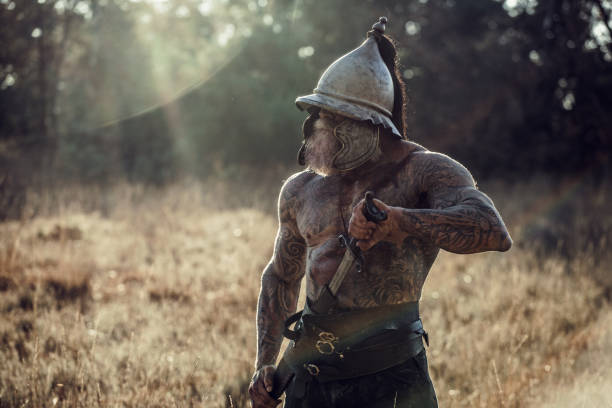 istock Sword wielding bloody viking warrior alone in a forest 1164079831