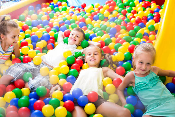 istock Group of kids playing on playground with plastic balls 1164080195