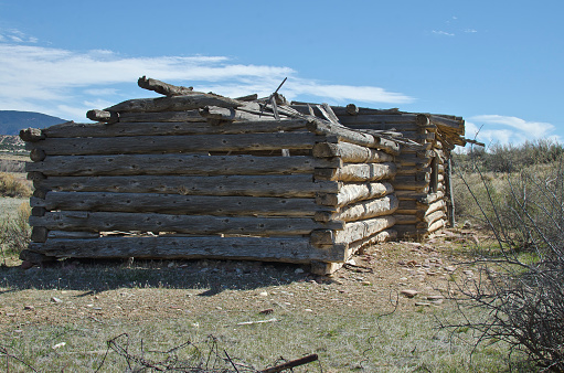 A view of the side of the  old wooden cabin in the dry dead heat of the old utah countryside in the desert landscape.