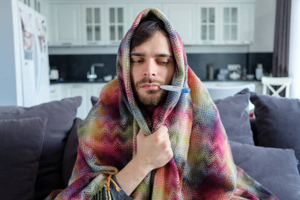istock The man with the temperature at home 1164082953
