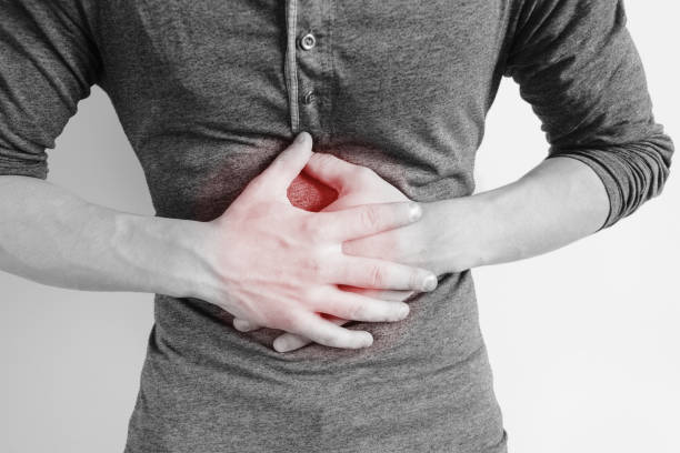 istock Man holding his sore belly 1164083074