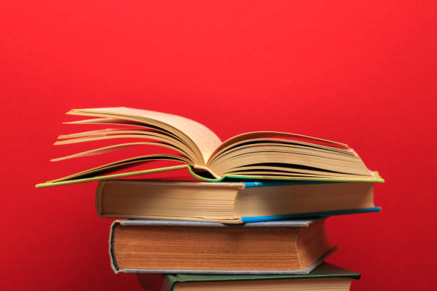 istock Opened Book on a pile of old books, panorma, good copy space -Image 1164083458