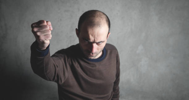 istock Caucasian angry and aggressive man threatening with fist. 1164084129