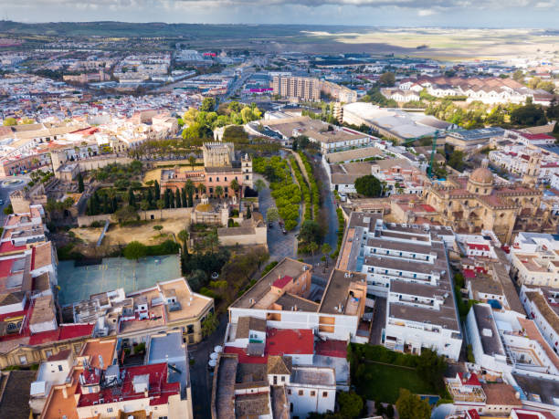 View from drone of Jerez de la Frontera with Cathedral and Moorish alcazar View from drone of residential areas of Spanish town of Jerez de la Frontera with Catholic Cathedral and former Moorish alcazar jerez de la frontera stock pictures, royalty-free photos & images