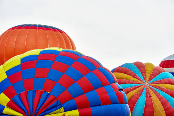 istock Multi coloured hot air balloons against a grey cloudy sky 1164084412