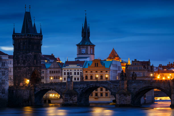 Prague Morning view of Charles Bridge and Old Town Bridge Tower over river Vltava."n old town bridge tower stock pictures, royalty-free photos & images