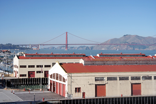 Fort Mason docks and warehouses with Golden Gate Bridge in background. Horizontal.-For more Golden Gate Bridge images, click here.  GOLDEN GATE BRIDGE 