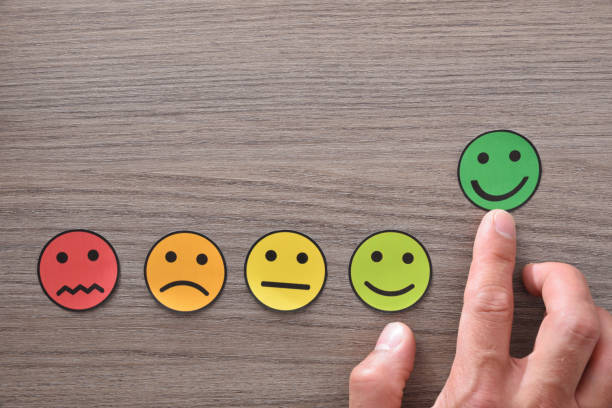istock Hand pointing a positive satisfaction represented with emoticons on table 1164086900
