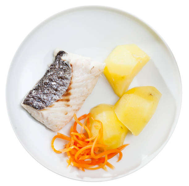 istock Codfish prepared on steam  with potatoes and carrots at plate 1164089159