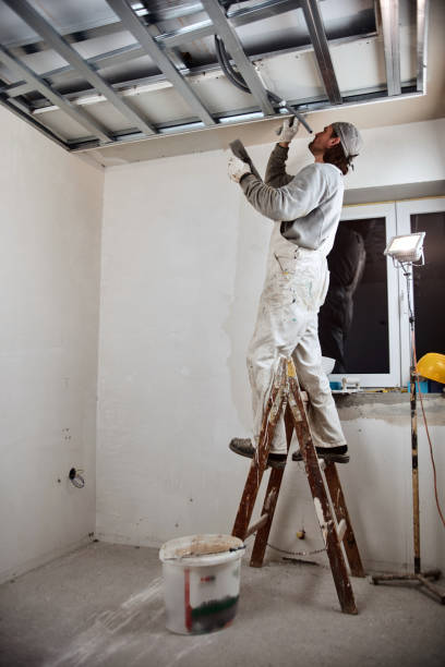 istock Construction worker plastering gypsum walls inside the house. 1164090402