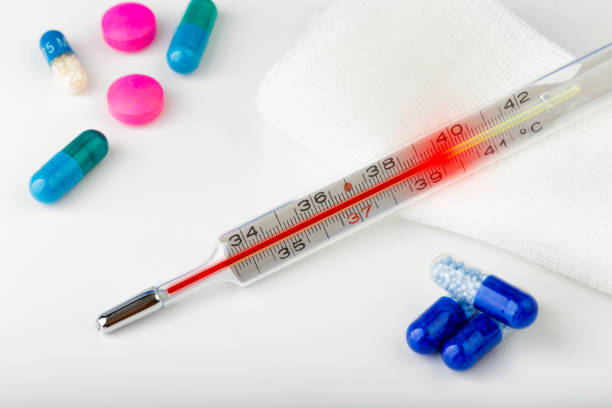 A medical digital thermometer on a plain background