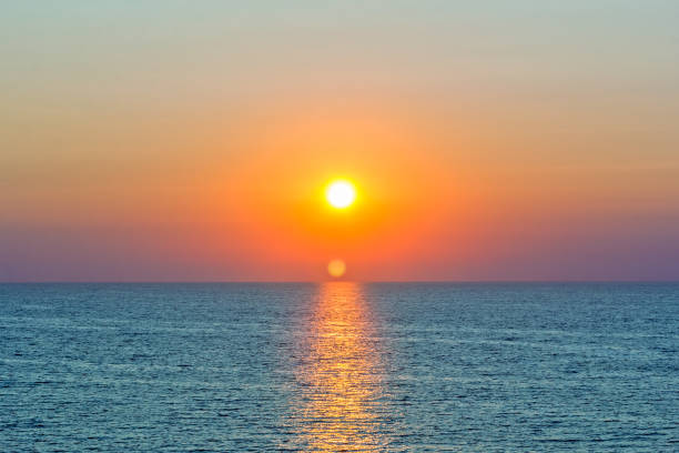 istock Scenic orange sunset and sun path in the blue sea 1164091389