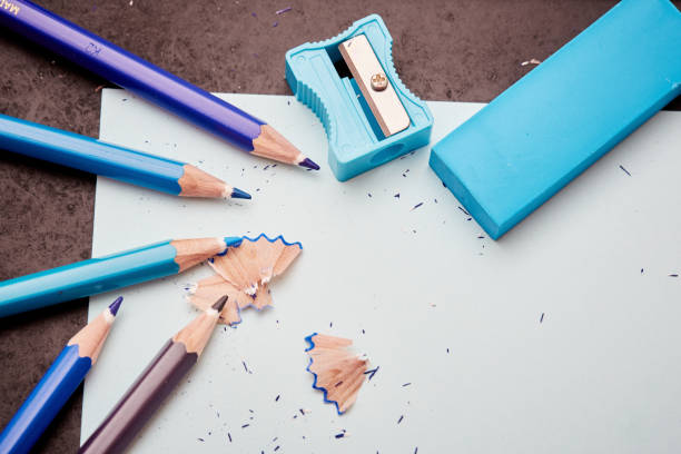 istock Five crayons, a pencil sharpener, eraser and shavings on paper 1164091460