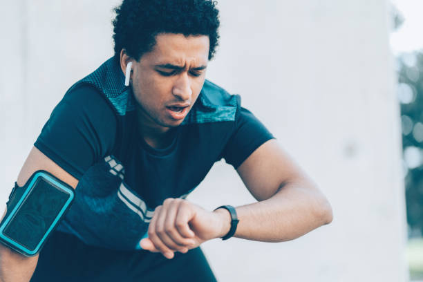 istock Exhausted sportsman checking his smart watch 1164091555