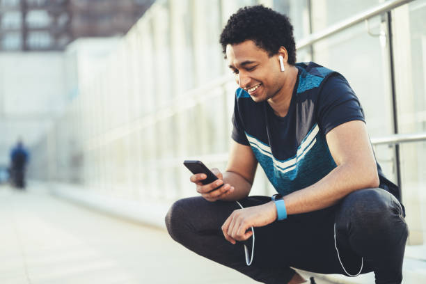istock Male athlete with smart phone 1164091563