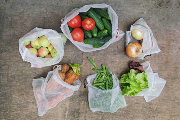 istock Zero waste shopping concept. No single-use plastic. Fresh organic vegetables, fruits and greens in reusable recycled mesh produce bags on wooden background. Flat lay. 1164091817