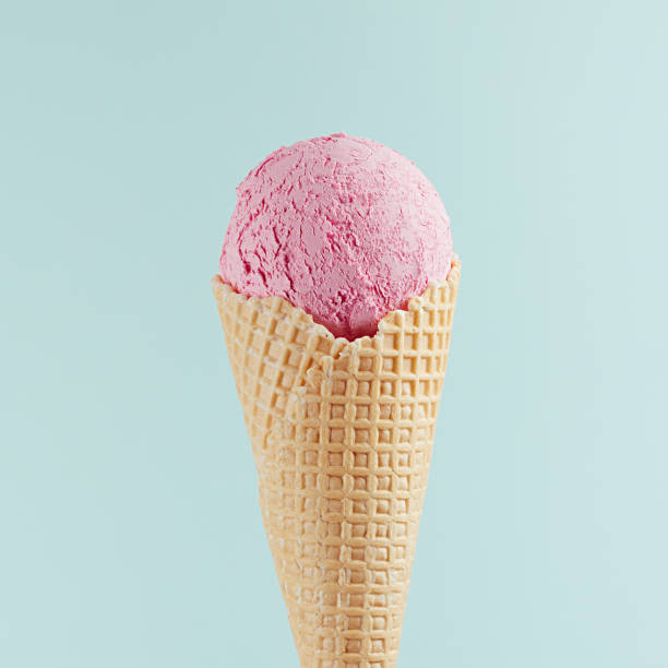 istock Flavor pink ice cream in crisp waffle cone on soft light pastel green background, square, closeup, top. 1164092627