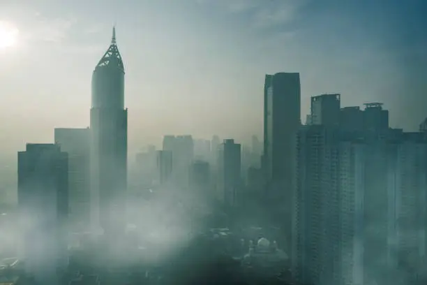 JAKARTA - Indonesia. April 24, 2019: Aerial view of skyscrapers with air pollution at morning time in Jakarta city