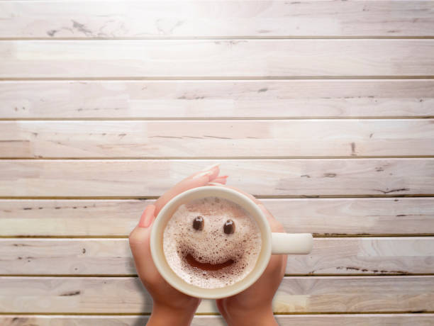froth milk foam smiles in a cup of coffee in morning. stock photo