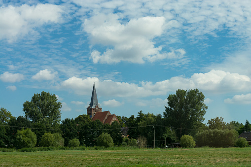 Countryside panorama blue sky Village church in the background