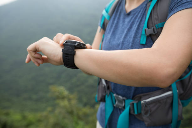 istock Woman hiker checking on smartwatch on mountain top 1164097555