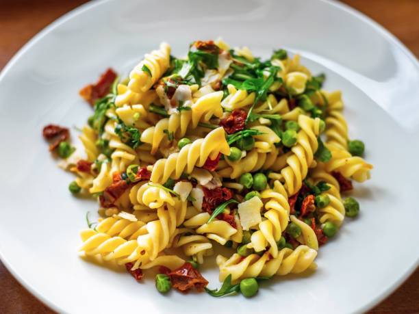 Fusilli pasta with vegetable on plate. stock photo