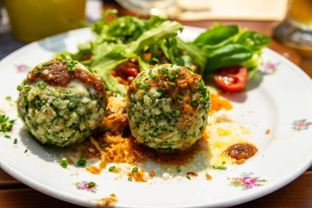 istock Green herb ball dumplings with rucola and sauce. 1164097872