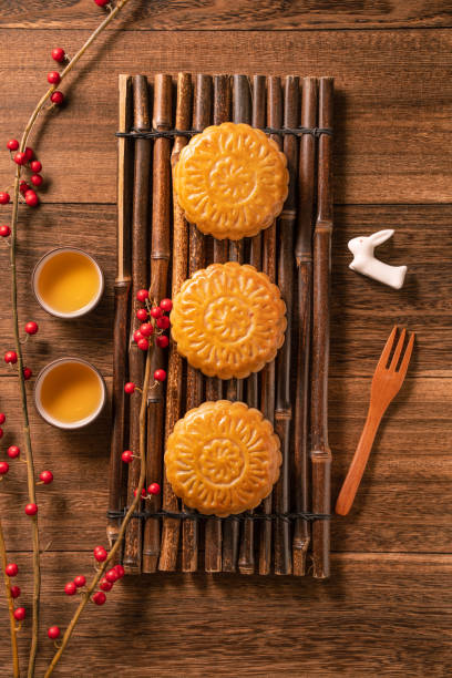 istock Creative Moon cake Mooncake table design - Chinese traditional pastry with tea cups on wooden background, Mid-Autumn Festival concept, top view, flat lay. 1164099241