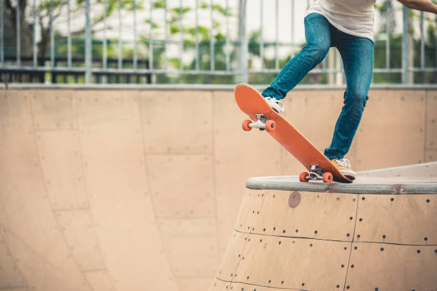 istock Skateboarder skateboarding at skatepark ramp 1164099414