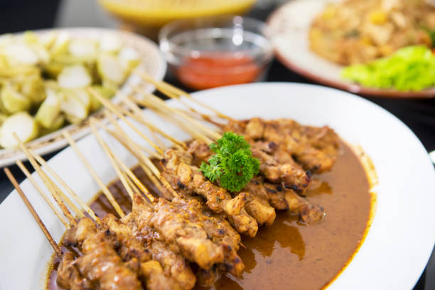 istock Tasty chicken satay served with other foods 1164099425