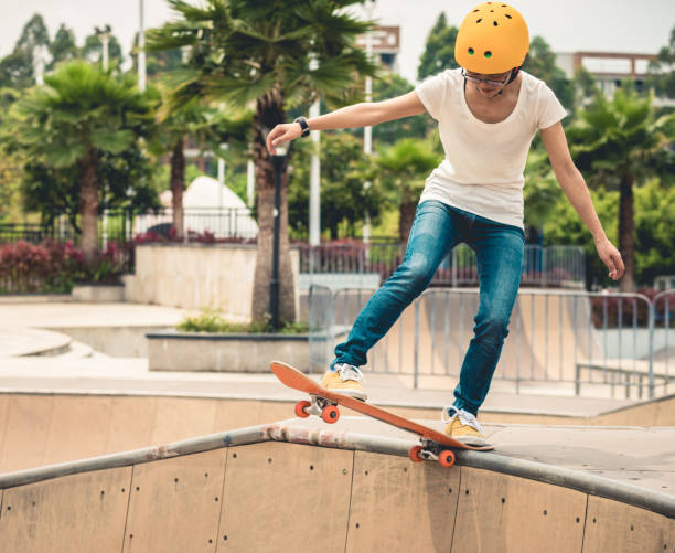 istock Skateboarder skateboarding at skatepark ramp 1164100297