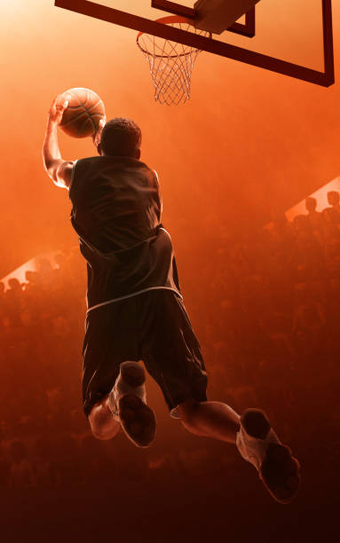 istock Basketball player making a basket. Jump shot. Slam Dunk 1164102866
