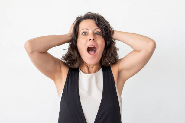 istock Shocked middle aged woman screaming 1164103389