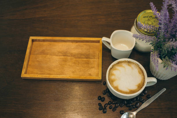 istock Coffee cup and coffee beans on wooden table  in cafe 1164103390
