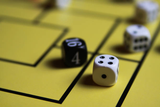 istock Close up of dices on yellow game board 1164104507