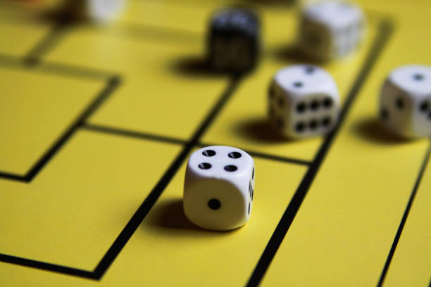 istock Close up of dices on yellow game board 1164104544